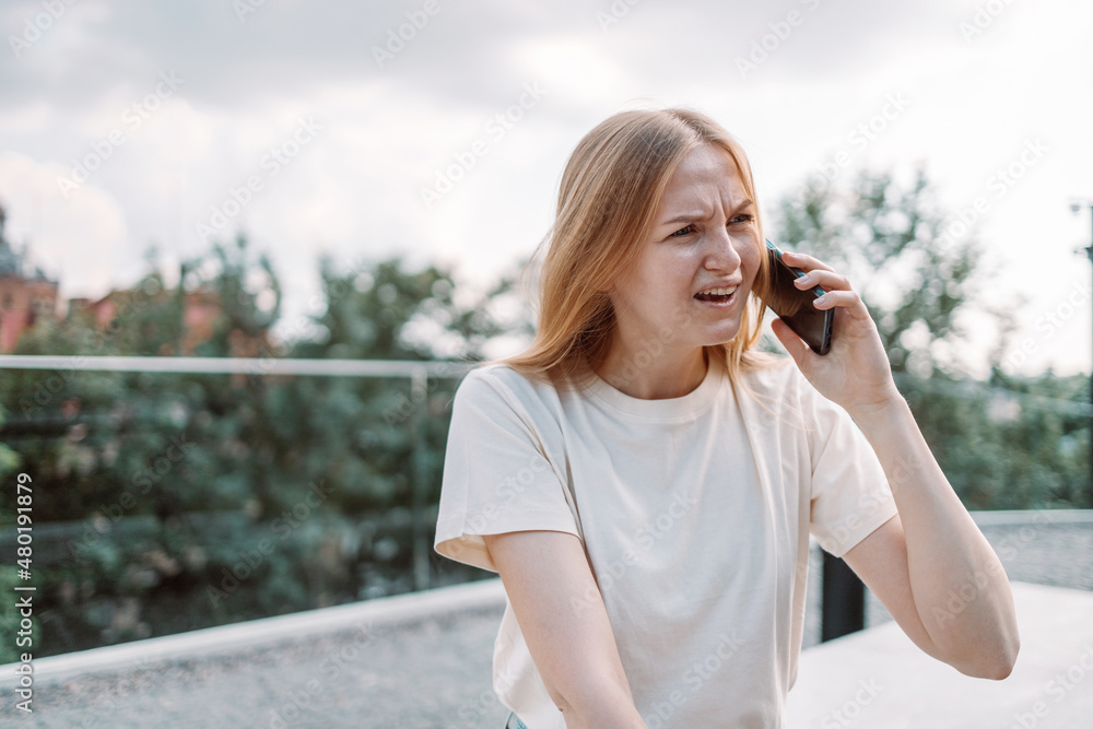Portrait of shocked girl woman travel tourist talking on smartphone spending sunny summer day outside. Facial expression concept Portrait of shocked girl woman travel tourist talking on smartphone spending sunny summer day outside. Facial expression concept