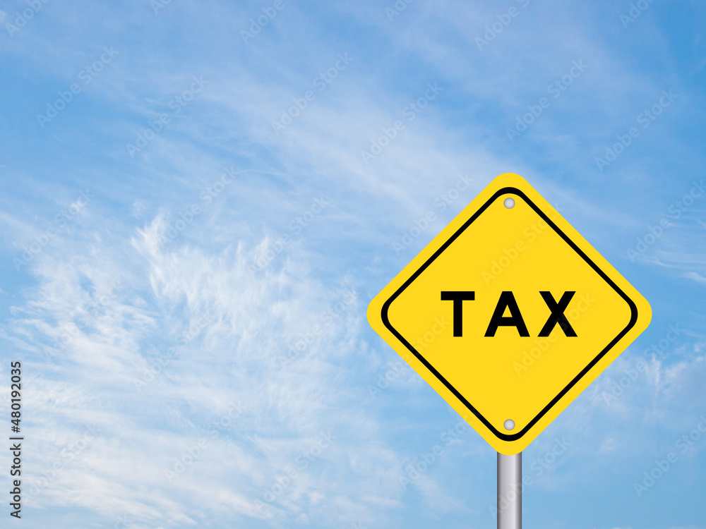 Yellow transportation sign with word tax on blue color sky background