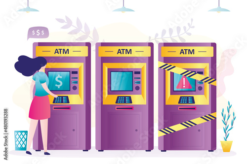 Woman withdrawals or deposits cash to credit card in terminal. Defective ATM covered with yellow warning tape