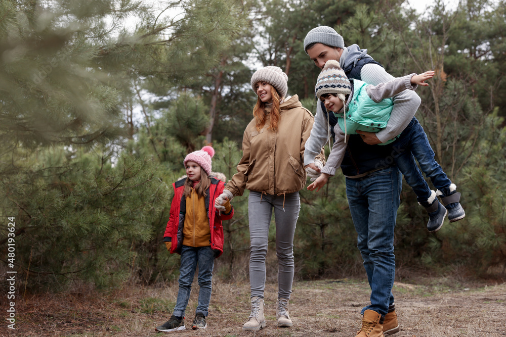 Happy family spending time together in forest Happy family spending time together in forest
