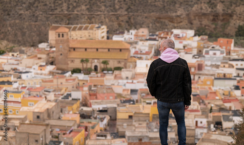 Rear view of man looking at view of town. Tabernas, Almeria, Spain © WeeKwong