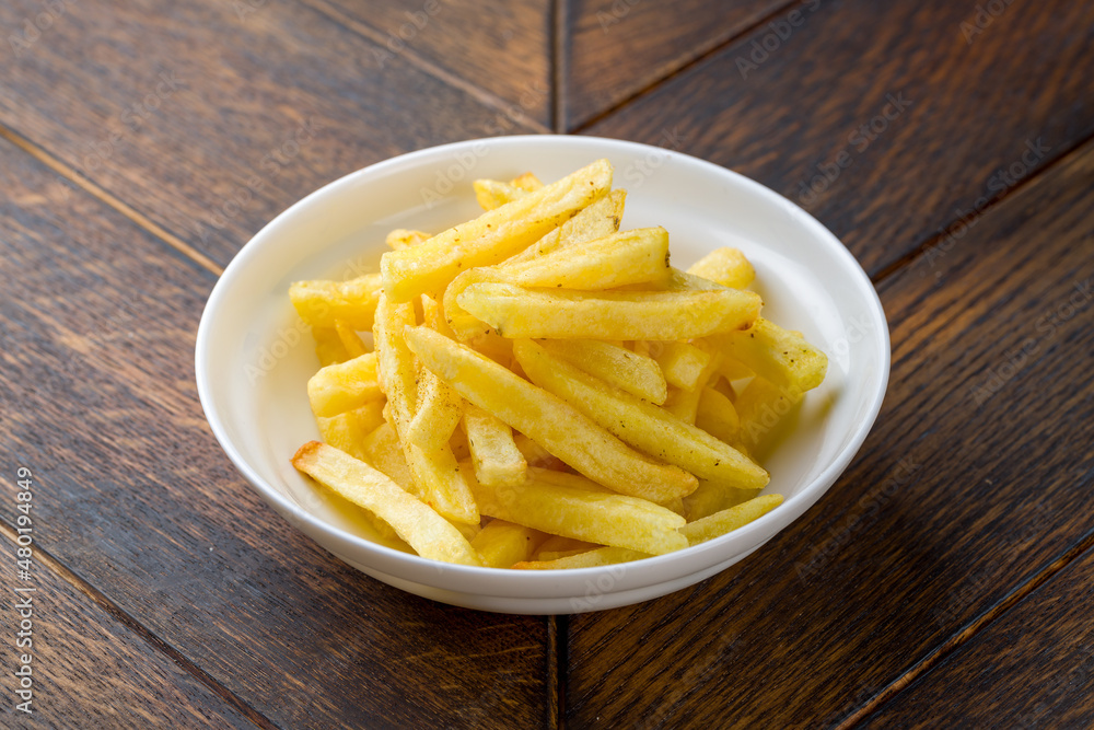 french fries on white plate on wooden table french fries on white plate on wooden table
