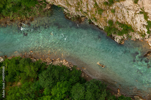 Mountain beautiful river with clear blue water, in the middle of the forest and stones. Natural untouched nature. Top view.