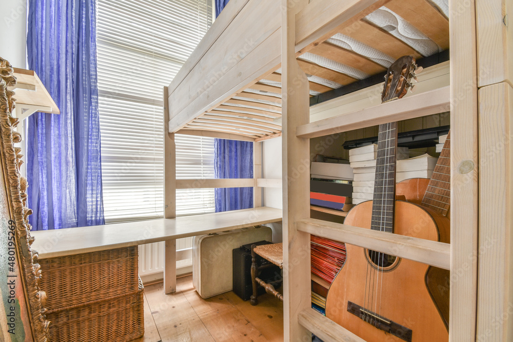 Teenager room with wooden bunk bed and desk and guitar Teenager room with wooden bunk bed and desk and guitar