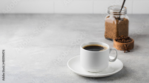 Konstfotografi Black instant coffee in a white mug on a gray background