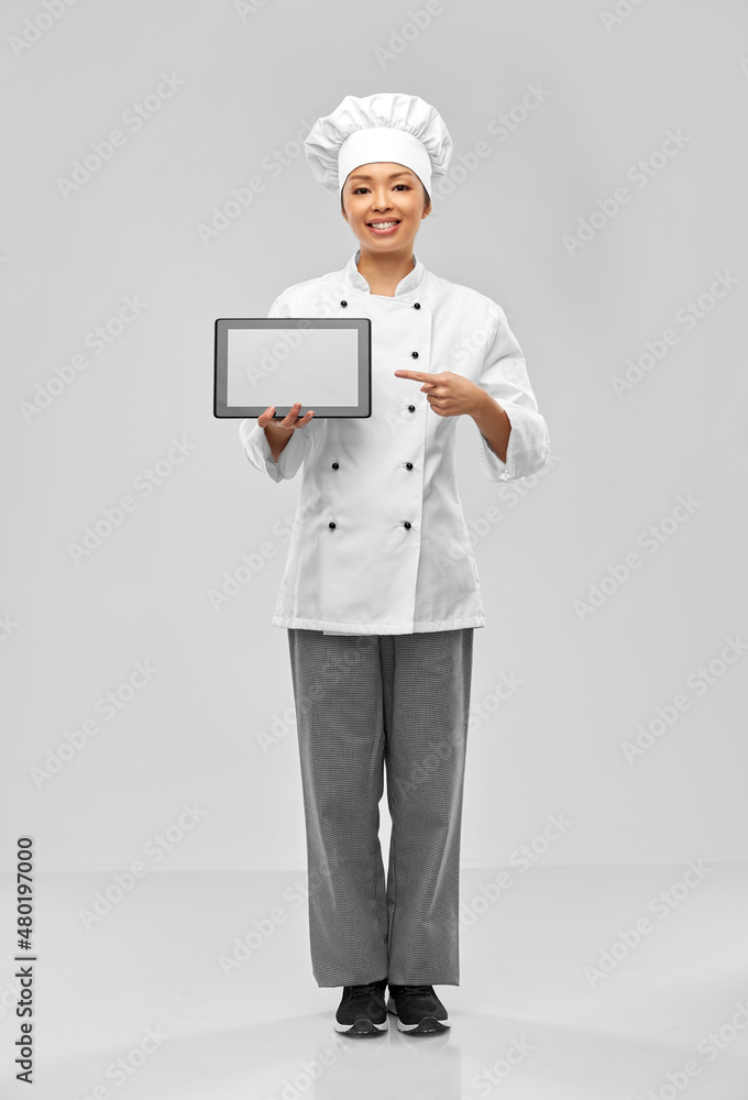 cooking, culinary and people concept - happy smiling female chef with tablet pc computer over grey background cooking, culinary and people concept - happy smiling female chef with tablet pc computer over grey background