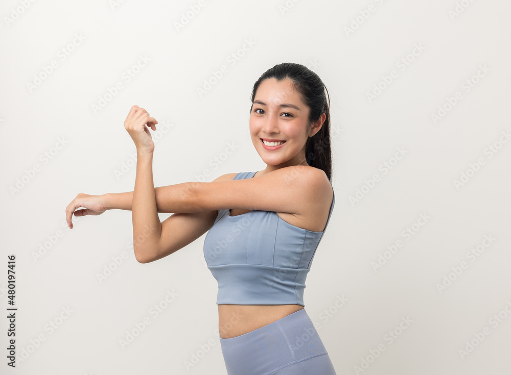 Young beautiful asian woman with sportswear stretching arms warming up on isolated white background. Portrait sporty woman standing pose exercise workout in studio.