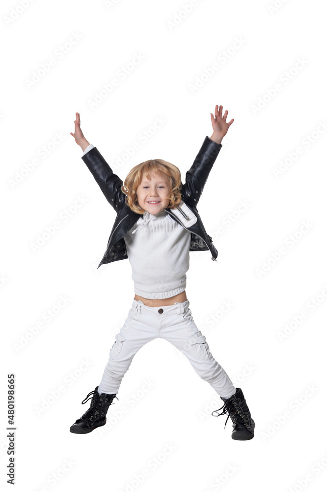 Portrait of handsome little boy jumping against white background