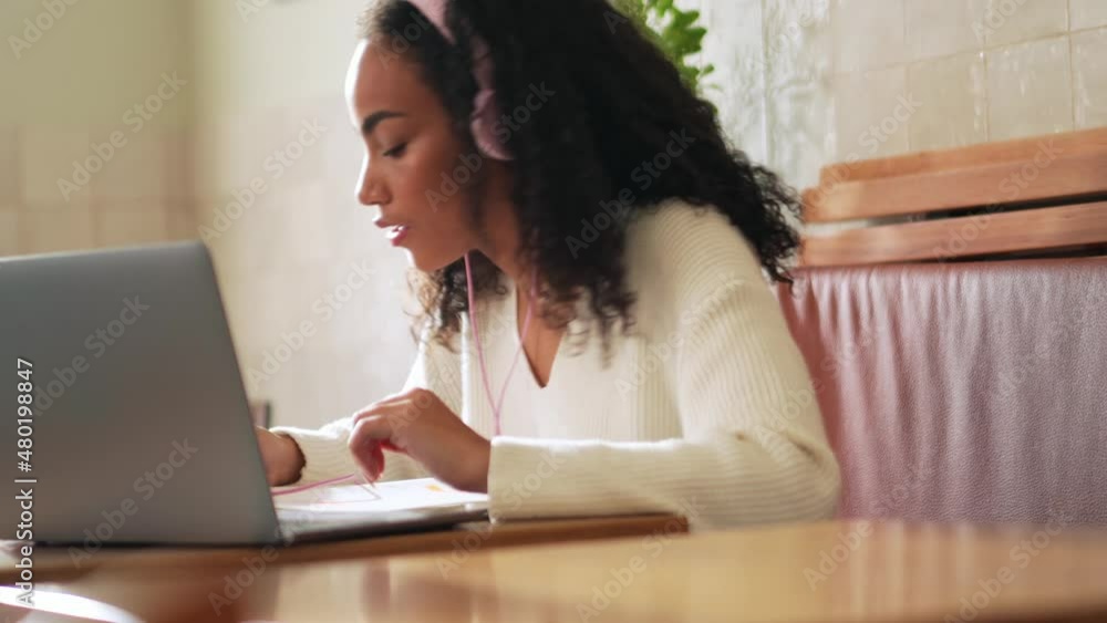 Confident African woman learning in cafe Confident African woman learning in cafe