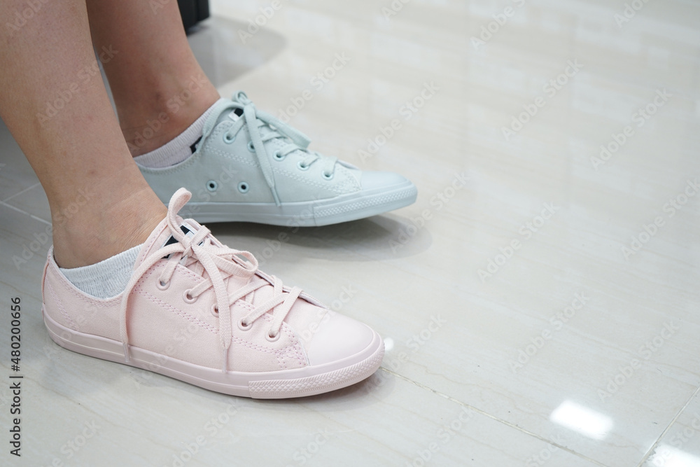 gal tries pastel sneakers pastel shade and colour in sports and fashion shoe shop. gal tries pastel sneakers pastel shade and colour in sports and fashion shoe shop.