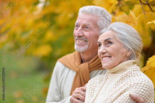 Portrait of happy senior woman and man in park
