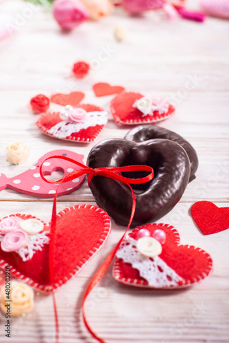 Fototapeta Naklejka Na Ścianę i Meble -  Cookies in shape of heart on white wooden table valentine background low angle view