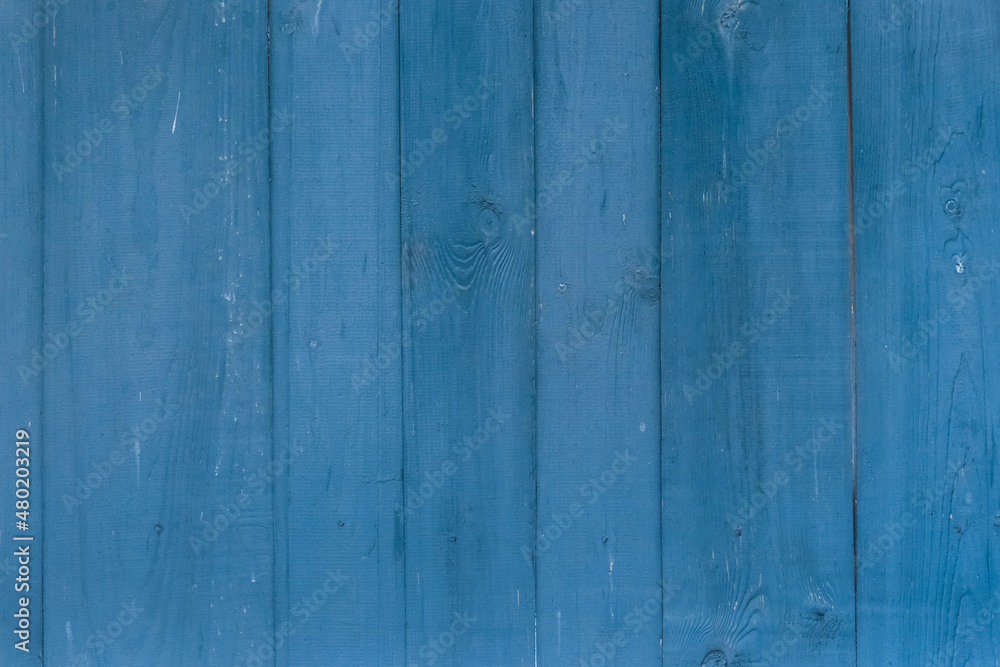 Fototapeta premium Blue paint on the surface of the boards of the old fence wooden texture background