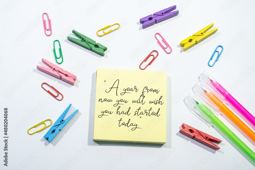 Text sign showing A year from now you will wish you had started today on Set of colorful paper clips with white copy space background. Text sign showing A year from now you will wish you had started today on Set of colorful paper clips with white copy space background.