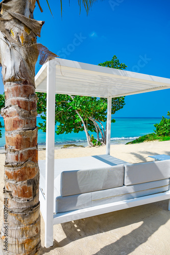 white bed on the sandy beach of the sea