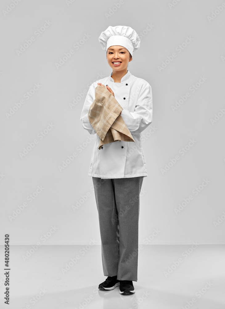 cooking, culinary and people concept - happy smiling female chef in white jacket with kitchen towel over grey background cooking, culinary and people concept - happy smiling female chef in white jacket with kitchen towel over grey background