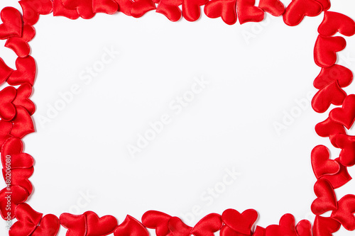 Fototapeta Naklejka Na Ścianę i Meble -  Valentine's day greeting card. Frame from red hearts on a white background. Layout with place for text.