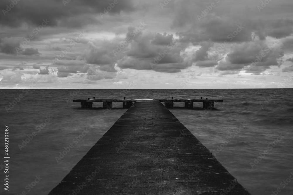 Fototapeta premium pier in the middle of the stormy sea