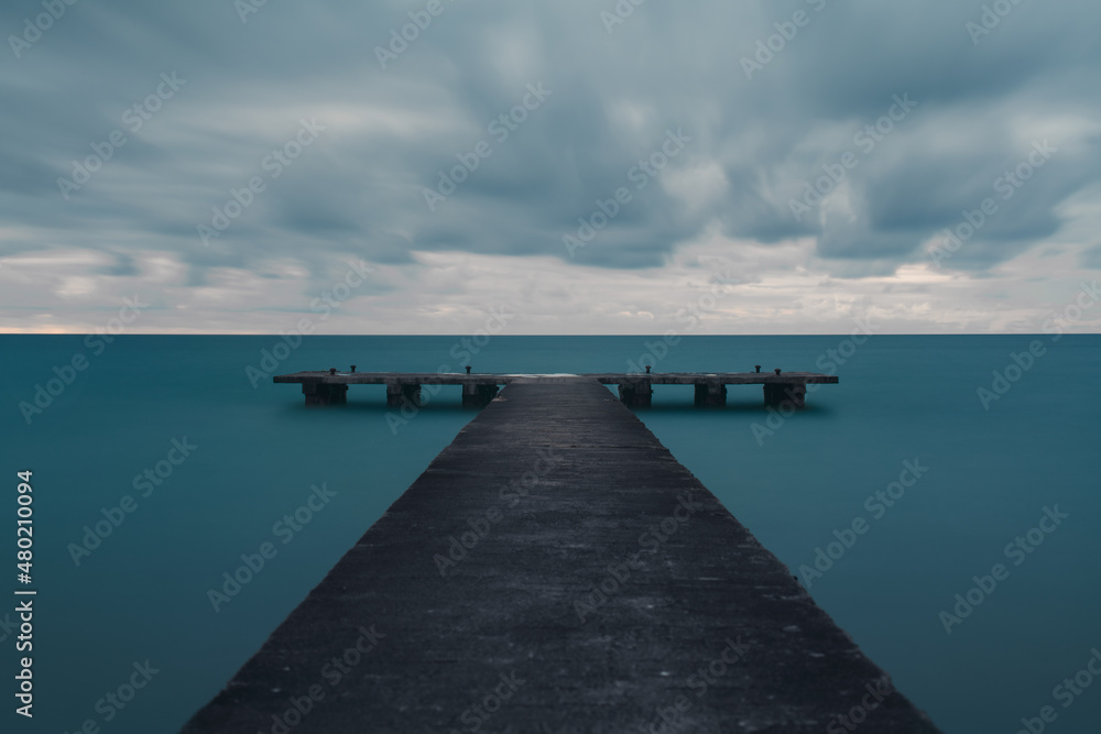 pier in the middle of the stormy sea