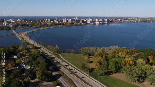 Flying Over John Nolen Drive towards Downtown Madison, Wisconsin Surrounded by Fall Colors (Drone - Tracking Left of Street)