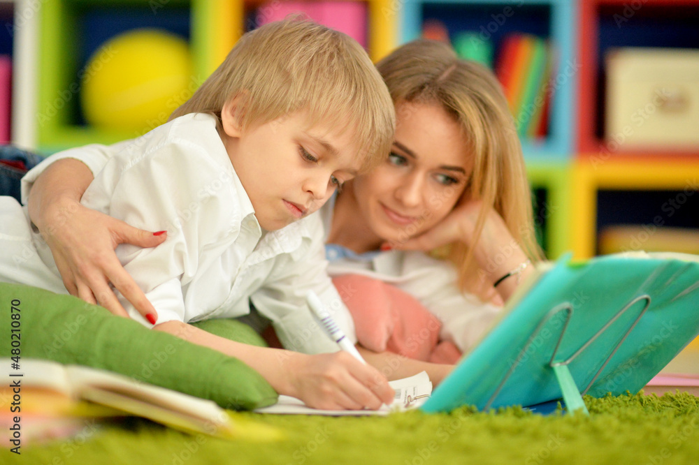 Mother with her son doing homework at home Mother with her son doing homework at home
