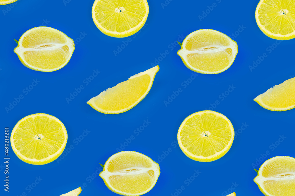 Fresh lemon seamless pattern on a bright blue color background. Top view, flat lay, design element.
