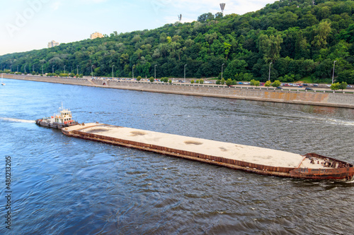 Heavy long barge sailing on the Dnieper river in Kiev  Ukraine