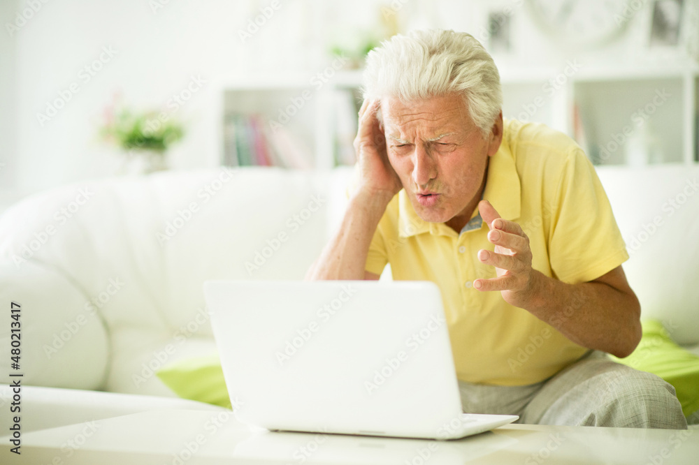 Portrait of emotional senior man using laptop Portrait of emotional senior man using laptop