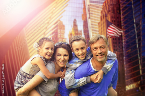 Portrait of happy beautiful family posing in NYC at summer