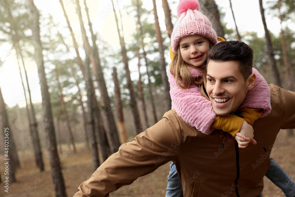 Fototapeta premium Man and his daughter spending time together in forest