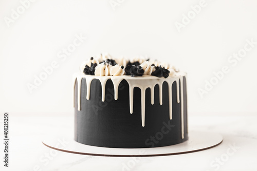 Fotografía Birthday cake with black cream cheese frosting and white chocolate drips on the
