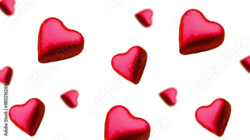 A stream of many different diameters heart shape wrapped colorful chocolate  candy flying on a white color background.Romantic template Love concept for mother's, St. Valentine's and women's  Day