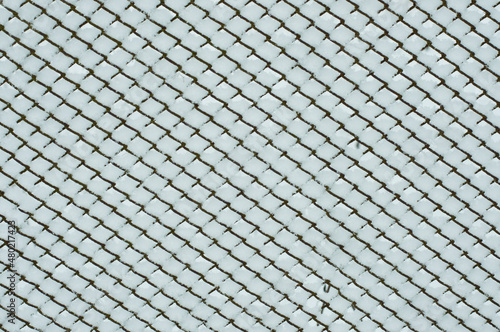 Fence metal mesh with snow.Winter background.