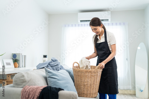 Fotografija Asian cleaning service woman worker cleaning in living room at home
