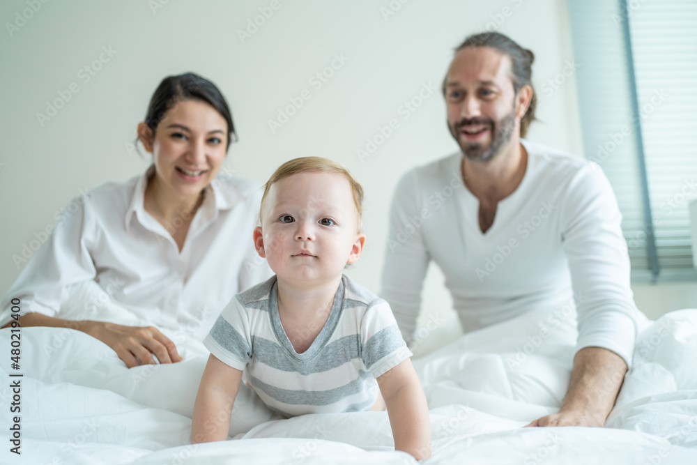 Portrait of Caucasian happy family smiling, look at camera in bedroom. Portrait of Caucasian happy family smiling, look at camera in bedroom.