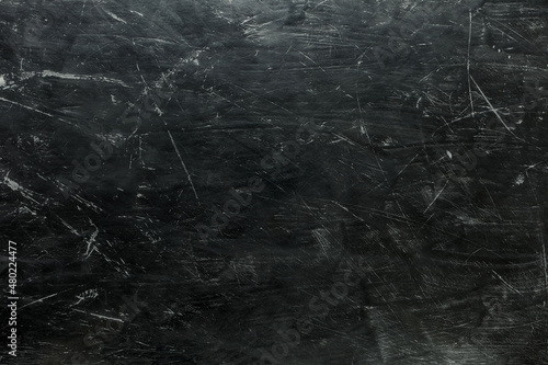 Dark grey background with scratches.