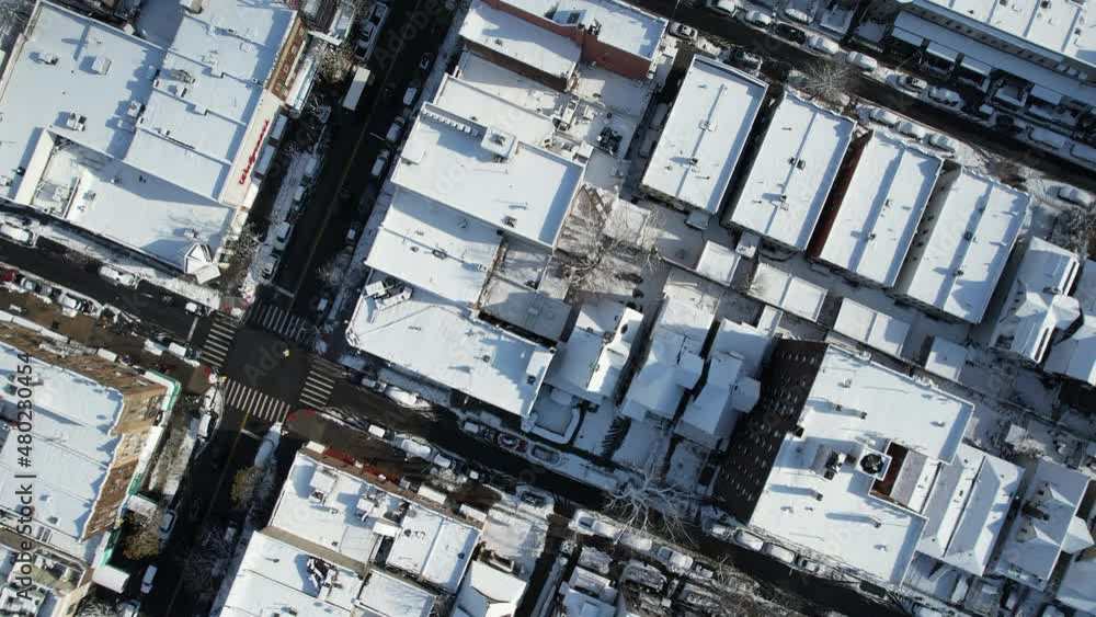 Downward sweeping aerial shot of Snowy rooftops in Brooklyn New York, Brooklyn in the snow Downward sweeping aerial shot of Snowy rooftops in Brooklyn New York, Brooklyn in the snow