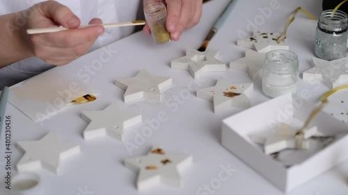 Applying Gold Leaf. woman Artist decorates the gold plaster craft. hobby and creativity concept. photo