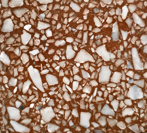real brown terrazzo stone texture background for interior vintage mood and tone. white and grey irregular stone fragments on brown stone background. trendy and stylish composite stone texture.