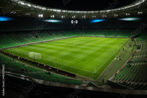 An open football stadium with empty stands with green seats. photo