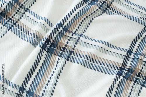warm plaid background in blue, white and beige colors
