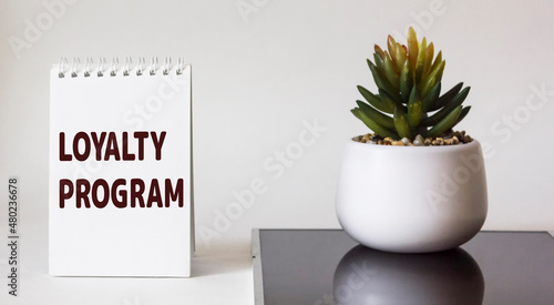 Notepad with word Loyalty program on white background photo