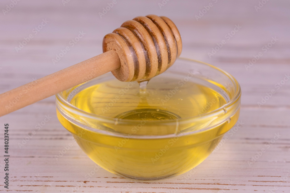 Honey in a transparent glass bowl. Close-up. Honey in a transparent glass bowl. Close-up.