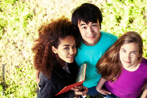 cute group of teenages at the building of university with books huggings, diversity nations, having lunch