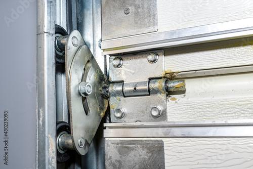 Grease lubricated double rollers in the guide for the backyard garage door, view from the inside.