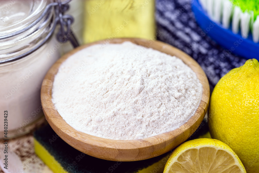baking soda with utensils around it, lemon and cleaning products baking soda with utensils around it, lemon and cleaning products