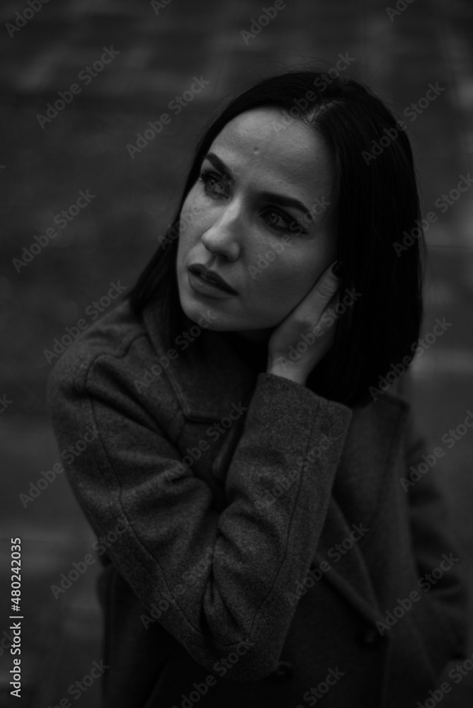 Black and white portrait of a young pretty woman walking on the streets of old european city. Black and white portrait of a young pretty woman walking on the streets of old european city.