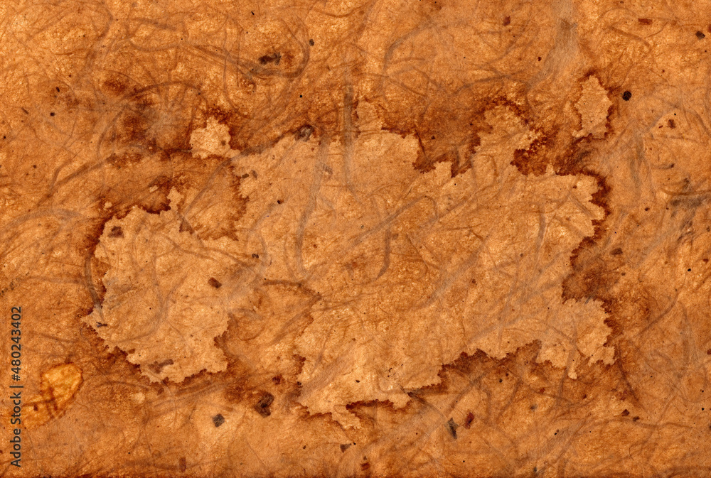 Old brown stained blank partchment paper background which has an aged and distressed texture which could be used as pirate map concept, stock photo image