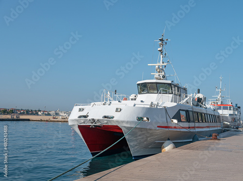 Fototapeta Naklejka Na Ścianę i Meble -  Large catamaran at the marina. Pleasure or passenger catamaran on the pier.