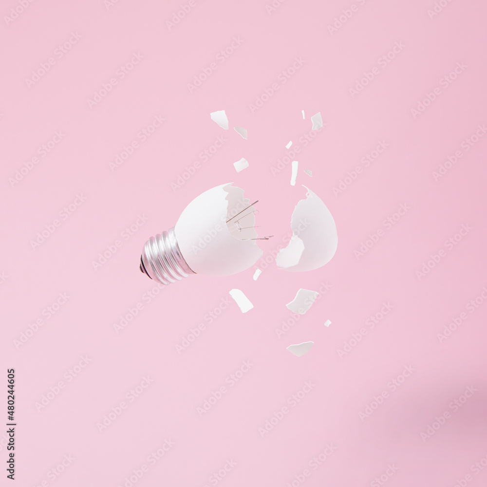 Egg lightbulb on pastel pink background with broken or shattered egg shell. Minimal concept. Easter inspiration. Flat lay. Egg lightbulb on pastel pink background with broken or shattered egg shell. Minimal concept. Easter inspiration. Flat lay.